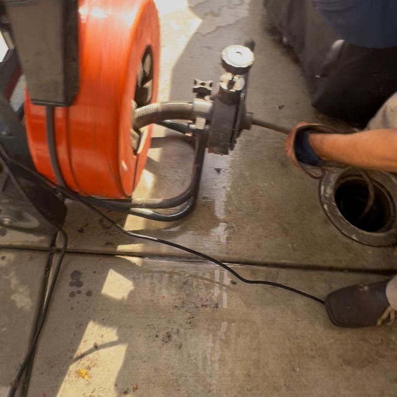 Main sewer line with drain snake clearing clog