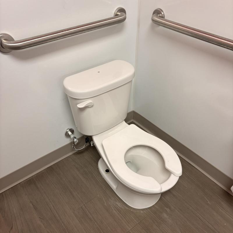 Youth-sized toilet with new open front seat installed