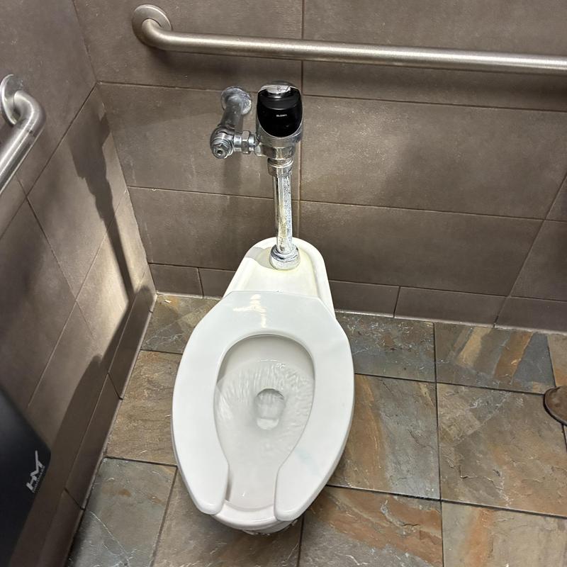 Vacuum breaker on ADA men's restroom toilet flush valve