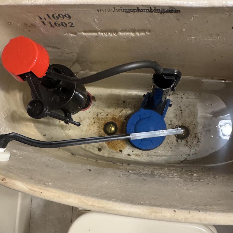 Toilet tank flapper and fill valve assembly inside tank