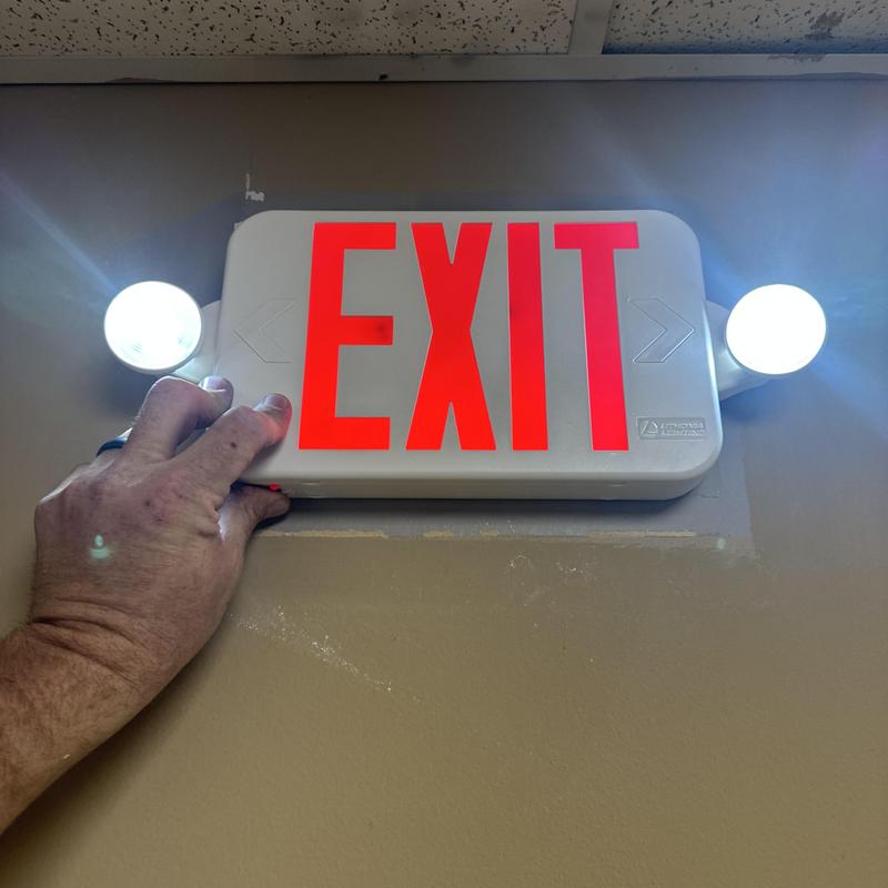 Exit sign with emergency lights being replaced Exit sign with emergency lights being replaced
