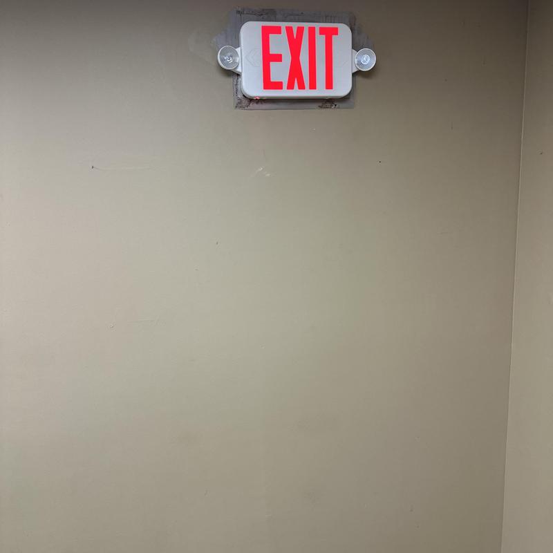 Exit sign lighting with emergency lights installed on wall Exit sign lighting with emergency lights installed on wall