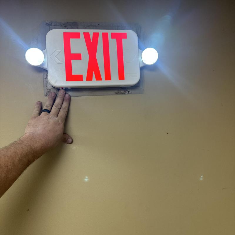 Exit sign with emergency lights installation in progress Exit sign with emergency lights installation in progress