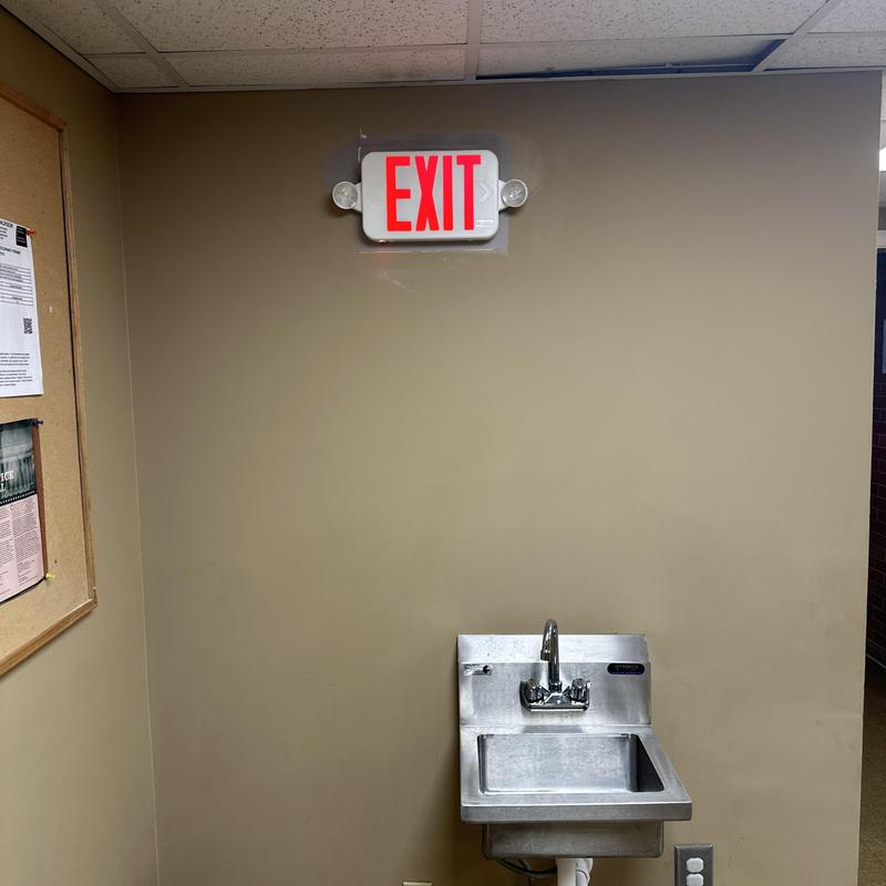 Emergency exit light replacement above stainless steel sink Emergency exit light replacement above stainless steel sink