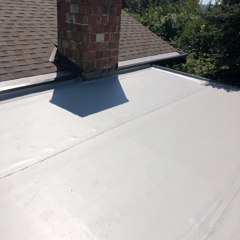 Flat roof membrane installation next to chimney