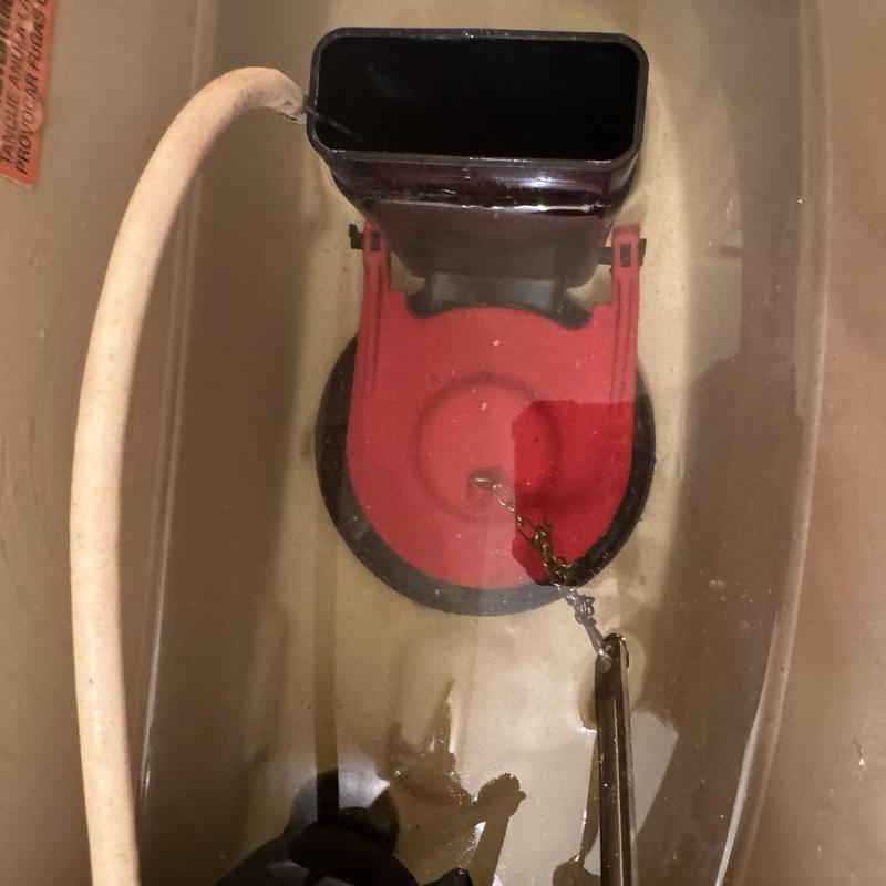 Toilet tank flapper with chain and fill tube inside