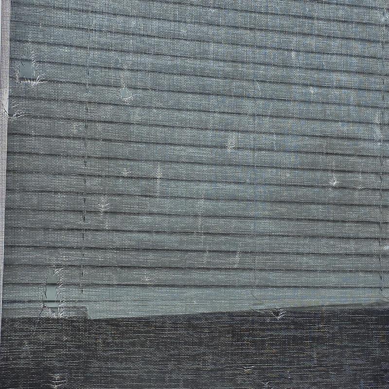 Roof underlayment with punctures and tears visible