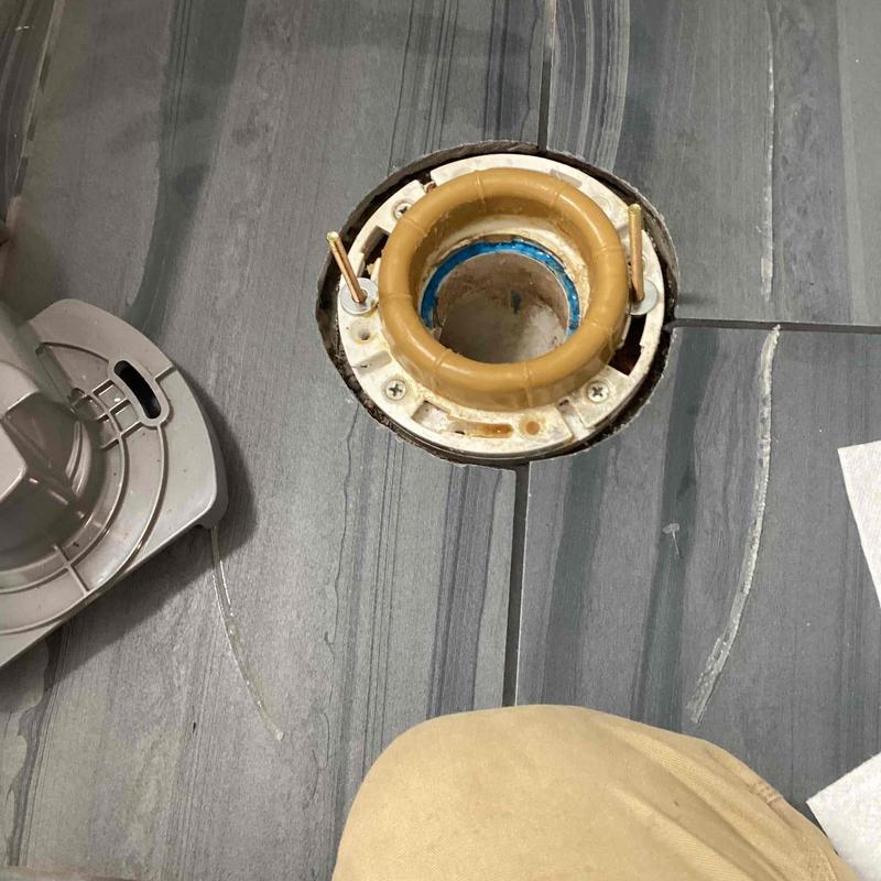 Toilet flange on bathroom floor with tile around