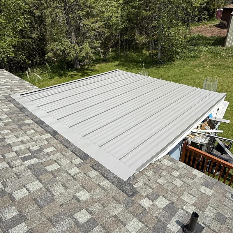 Standing-seam steel roof panel installation on porch roof