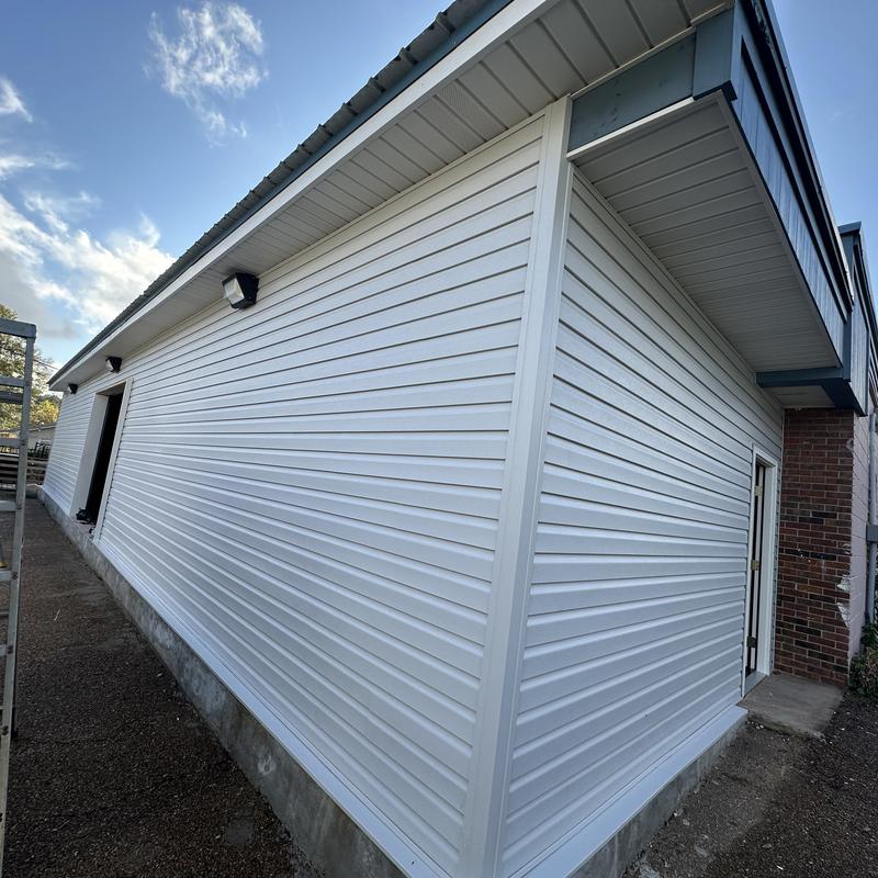 Vinyl siding installation on building exterior wall Vinyl siding installation on building exterior wall