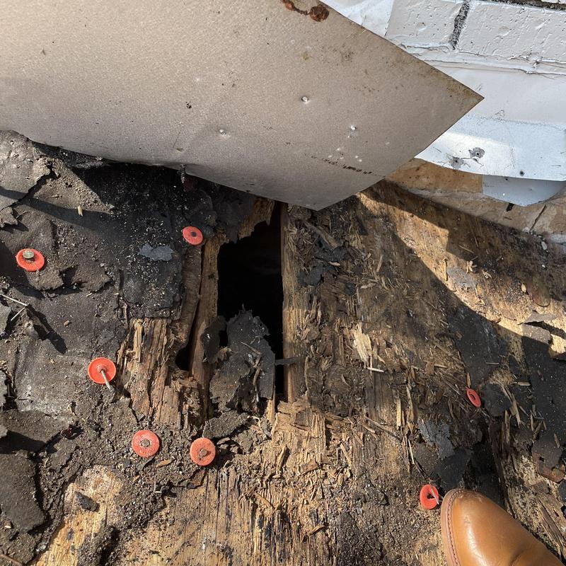 Chimney roof decking with hole and damage
