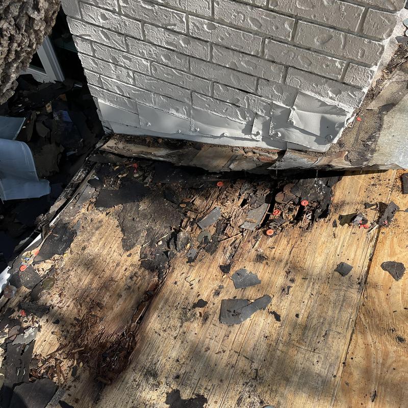 Chimney base wood decking damage on roof replacement