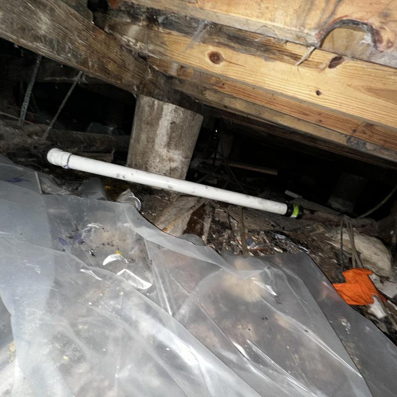 PVC branch drainage line beneath apartment complex