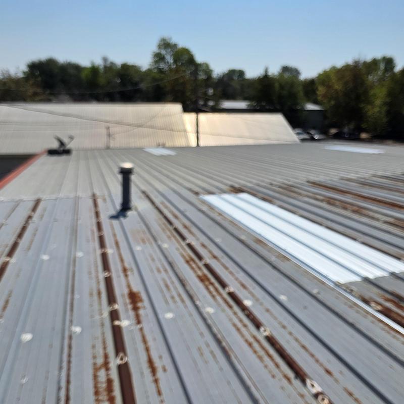 Metal roof panels with rust and patch repairs Metal roof panels with rust and patch repairs