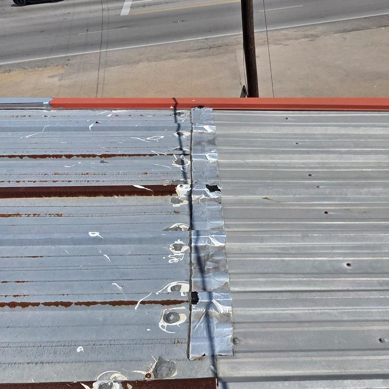 Metal roof with hail damage and patched seams Metal roof with hail damage and patched seams