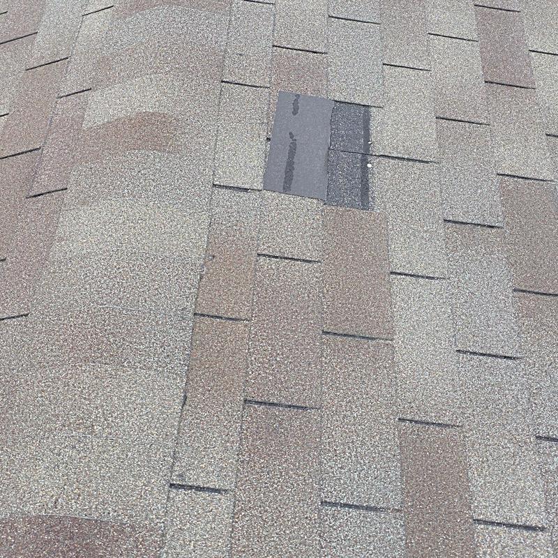 Roof shingles with missing granules and patch replacement