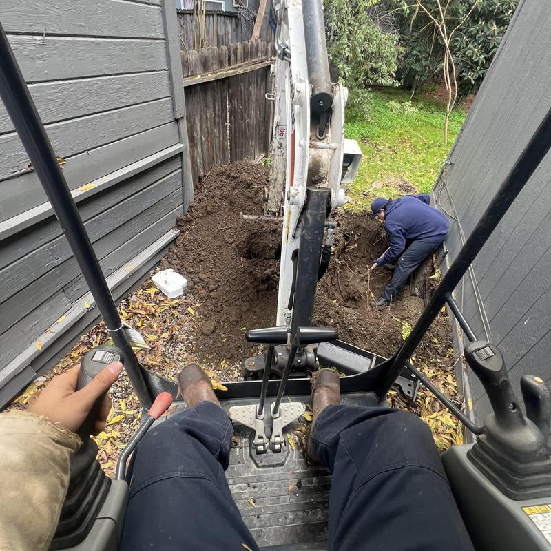 Leaky water line excavation and repair with backhoe