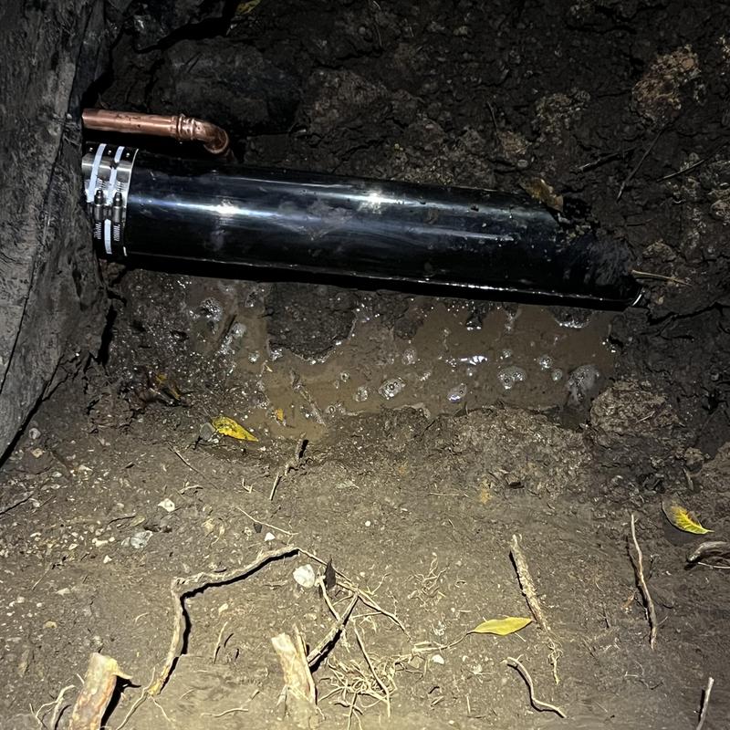 Waterline pipe reroute with copper connector in dirt hole