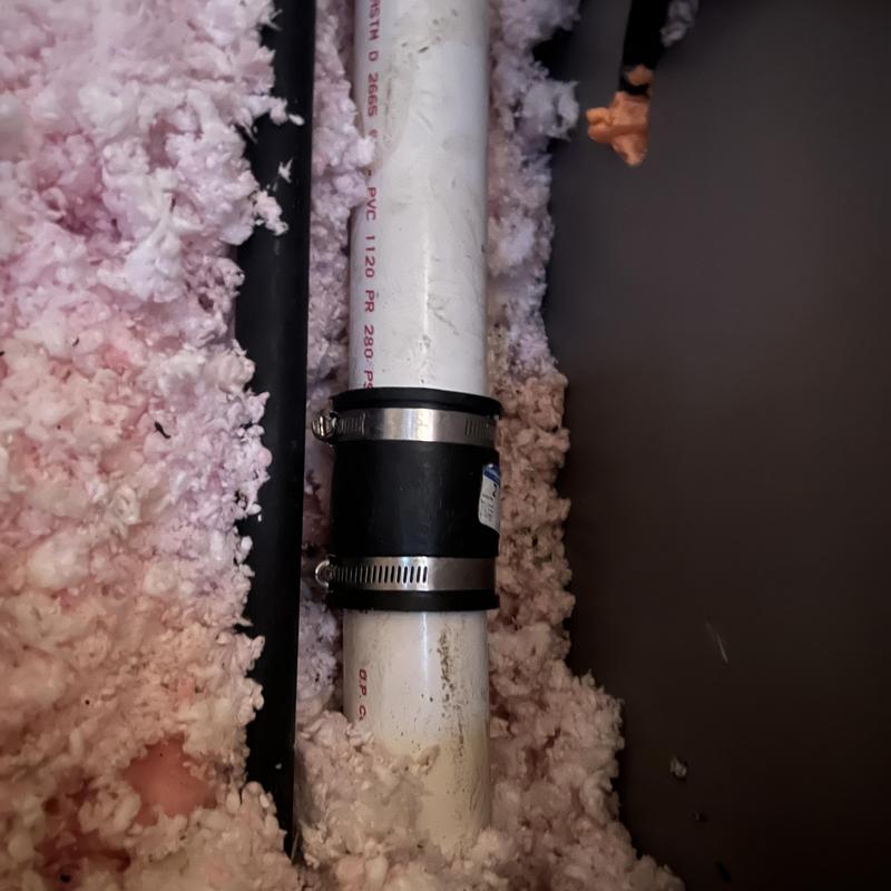 PVC vent stack with rubber coupling in attic insulation
