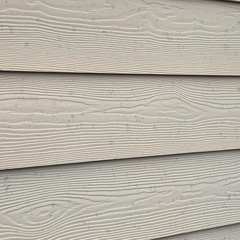 Siding with hail and wind damage marks