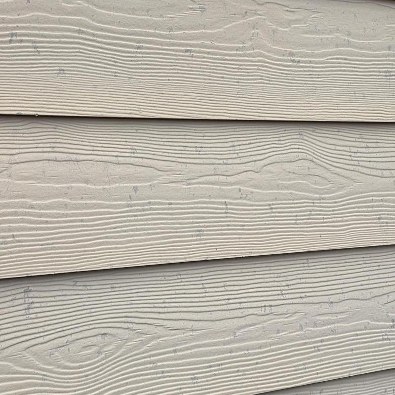 House exterior siding with hail damage marks