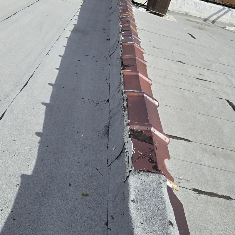 Roof flashing with damaged sealant after hailstorm