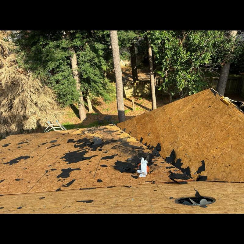 Roof decking with torn roofing paper during replacement