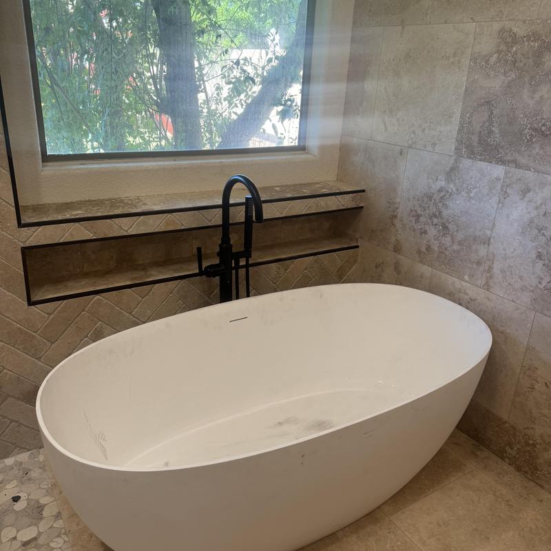 Freestanding black faucet with Roman tub in bathroom