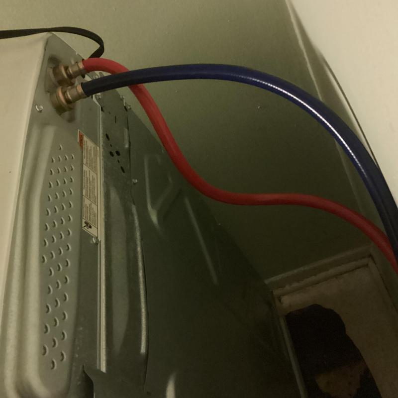 Washing machine hot and cold water supply hoses connected