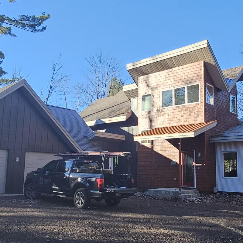Roof shingles inspection truck parked at modern home Roof shingles inspection truck parked at modern home