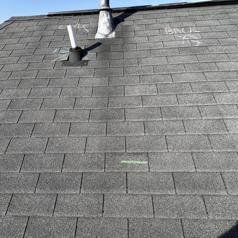 Roof shingles with unsealed wind creases near vents
