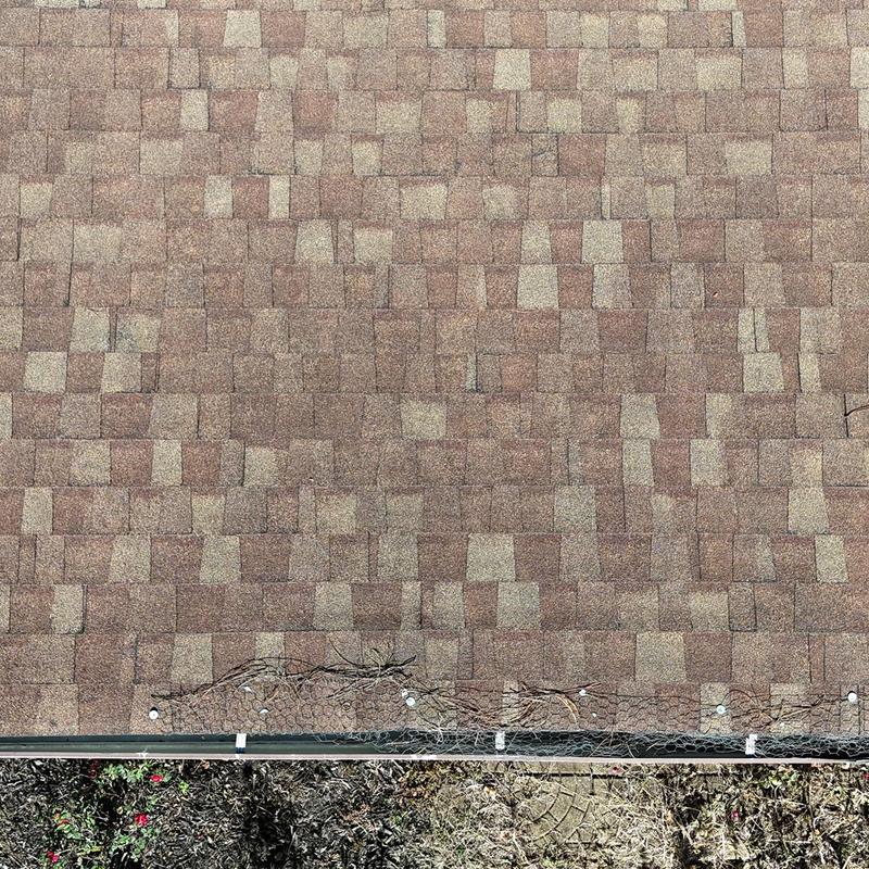 Porch roof shingles with debris and gutter guard installation