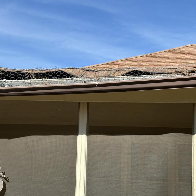 Porch roof edge with damaged fascia and gutter