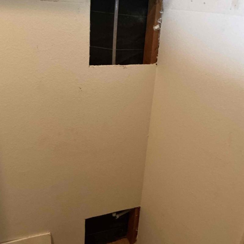 Hot water line reroute behind bathroom wall cutout