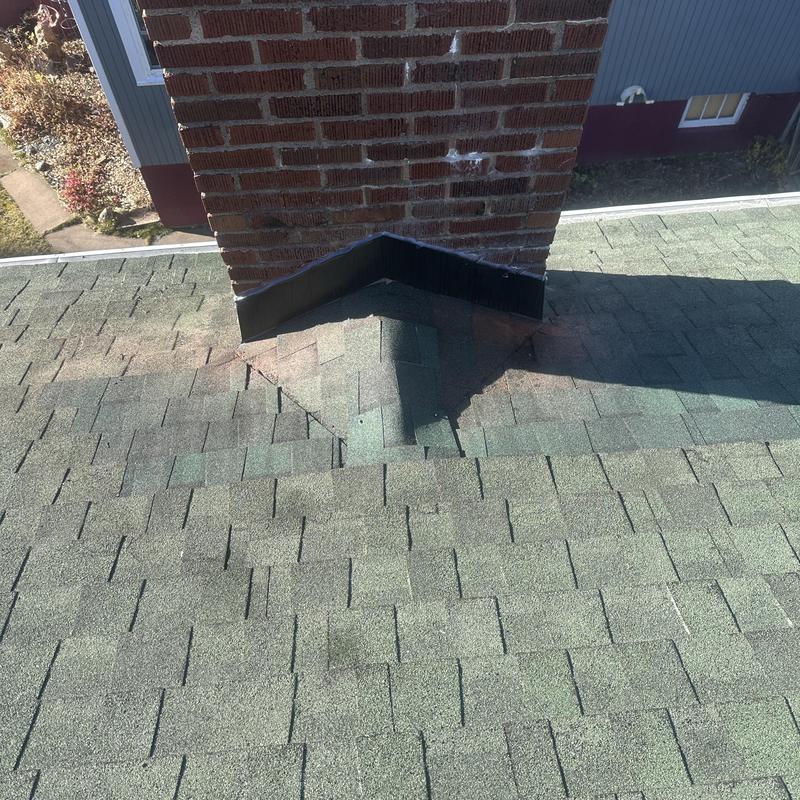Chimney saddle and flashing with new shingles Chimney saddle and flashing with new shingles