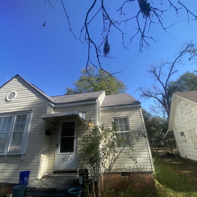 Composite shingle roof and siding on residential house Composite shingle roof and siding on residential house