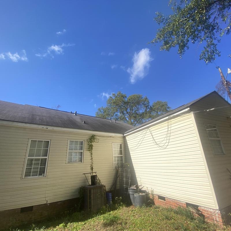 Composite shingle roof and vinyl siding on residential house Composite shingle roof and vinyl siding on residential house