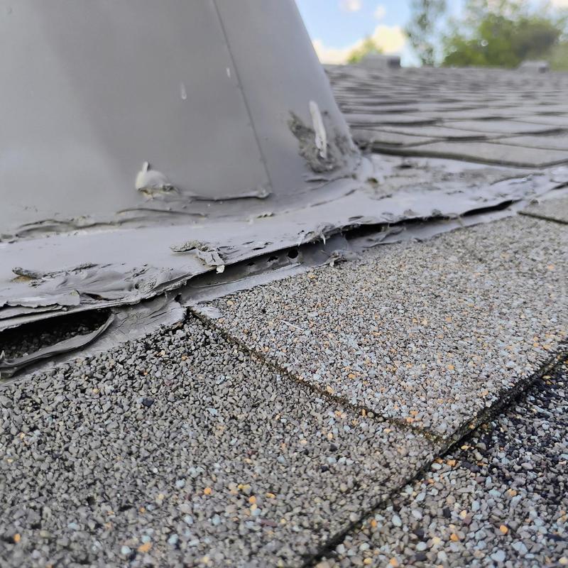 Roof flashing with hail damage and sealant wear
