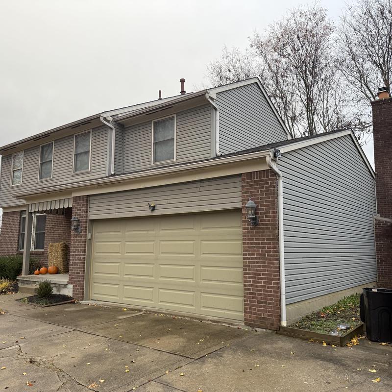 Vinyl siding and soffit inspection on townhouse exterior
