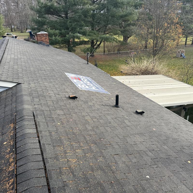Asphalt shingle roof with vent pipes and debris Asphalt shingle roof with vent pipes and debris