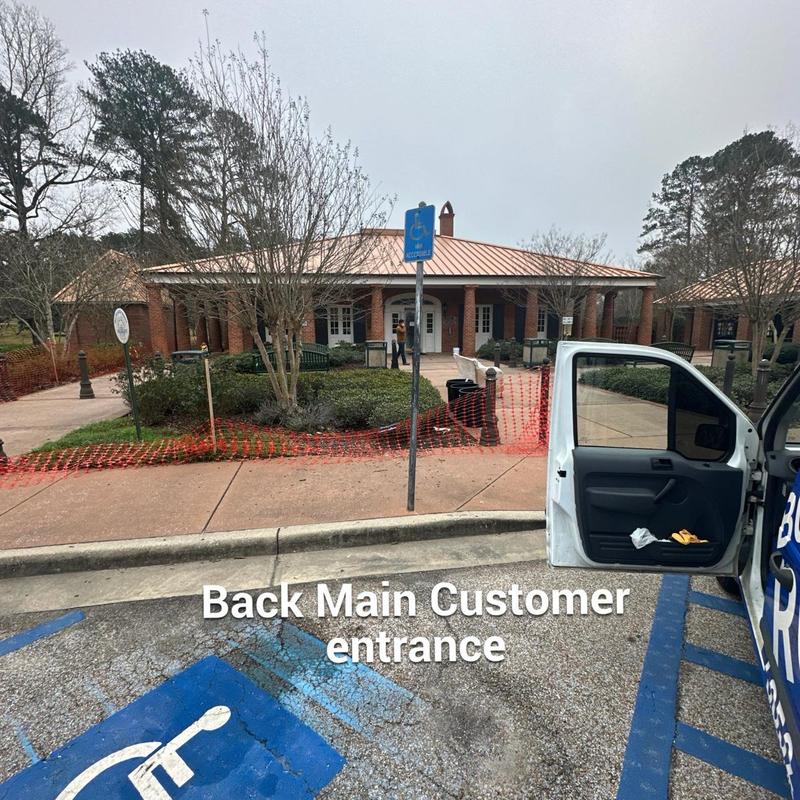 Rest area entrance with safety fencing and parking spaces Rest area entrance with safety fencing and parking spaces