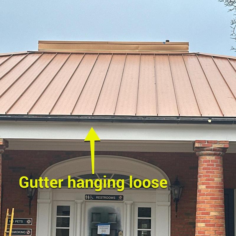 Metal roof with loose gutter inspection at rest area Metal roof with loose gutter inspection at rest area