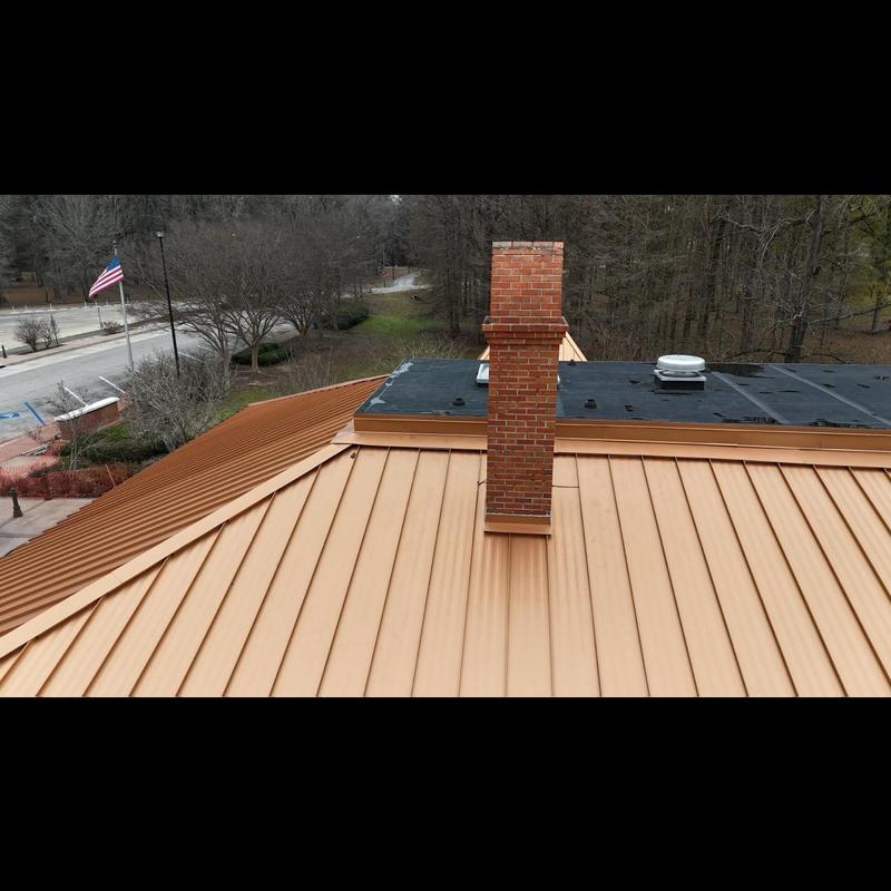 Metal roof panels with brick chimney inspection at rest area Metal roof panels with brick chimney inspection at rest area