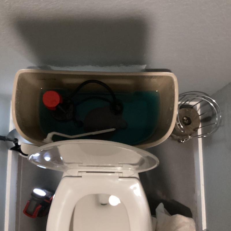 Toilet tank interior with refill valve parts
