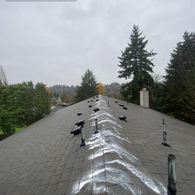Roof ridge and vent pipe flashing on shingle roof