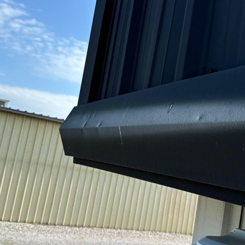 Metal roof edge trim with dents and surface damage