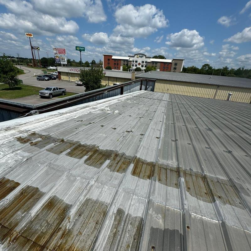 Metal commercial roof with membrane wear and seam exposure
