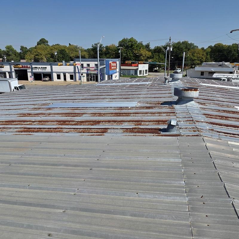 Metal roof panels with rust and damage from hail