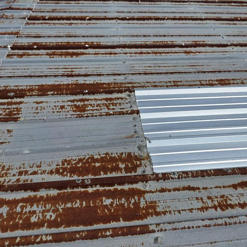 Metal roof panel with hail damage and patch replacement