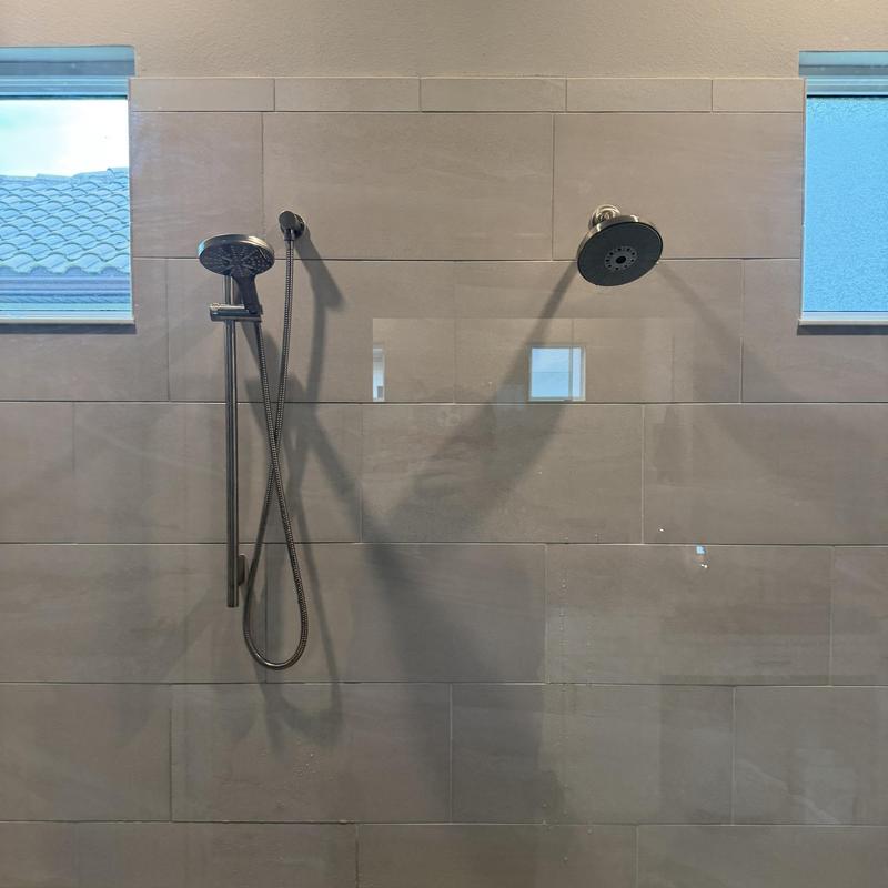 Shower heads and handheld shower bar installation in tiled wall